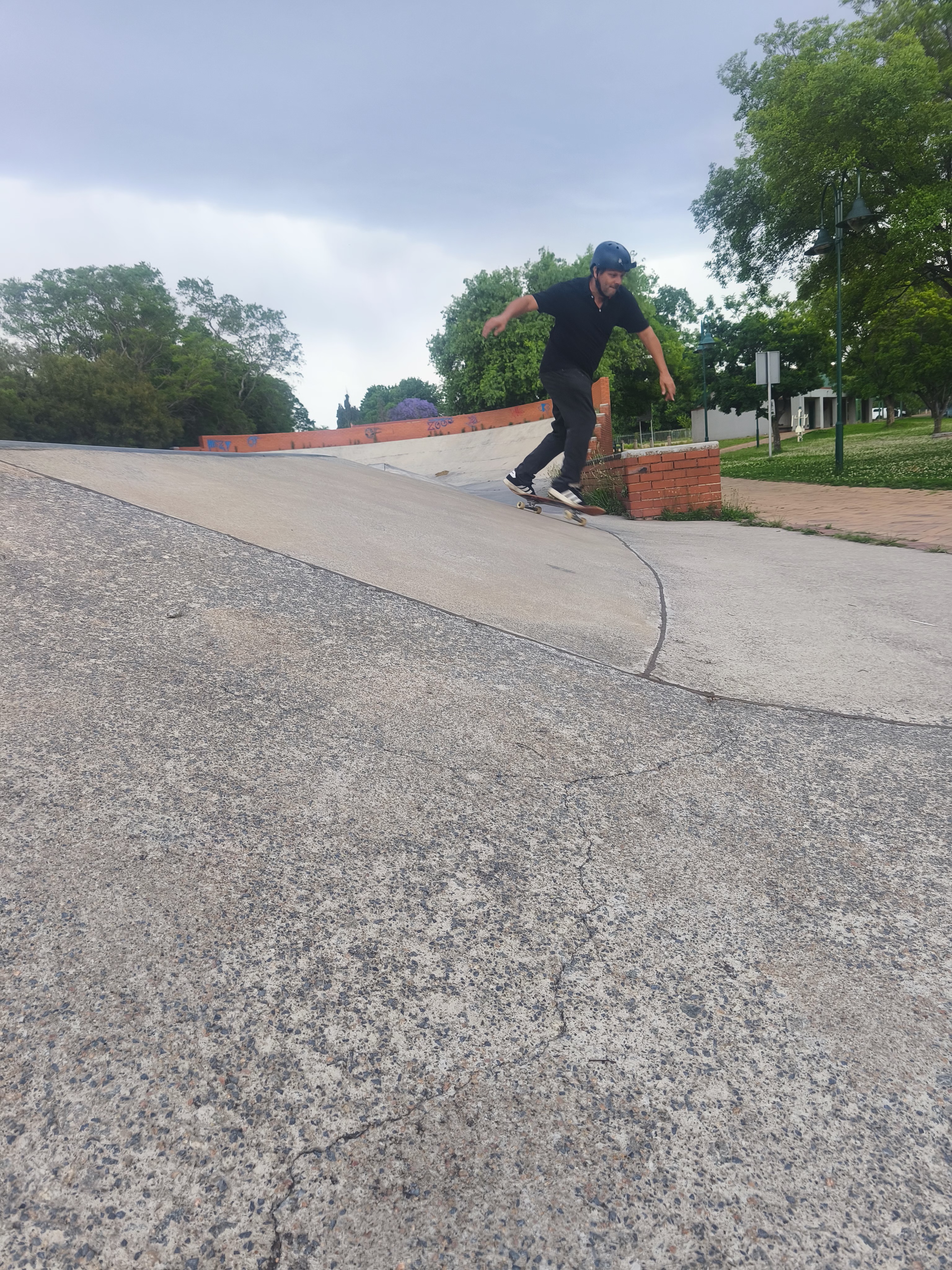 Raymond Koekemoer carving a concrete bank in South Africa at 54