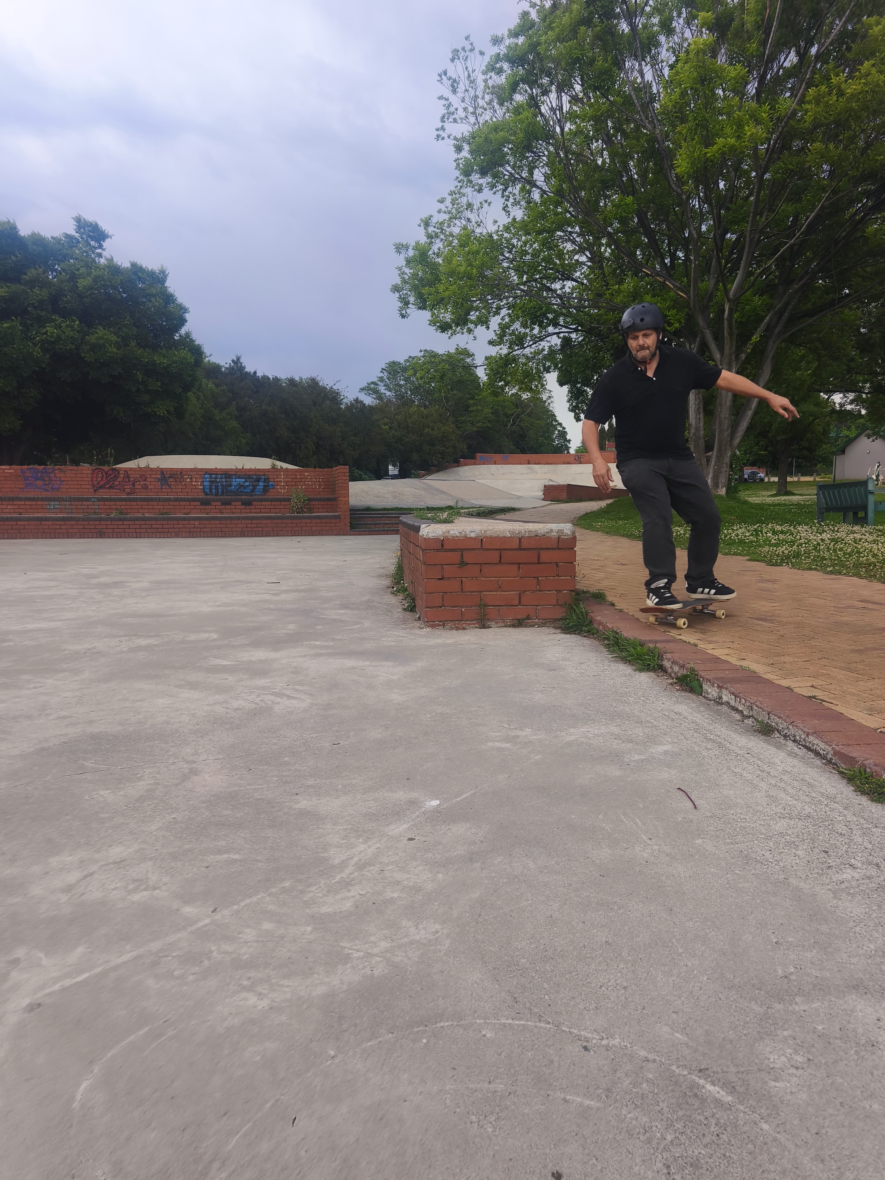 Raymond Koekemoer skating along a brick-lined path in South Africa